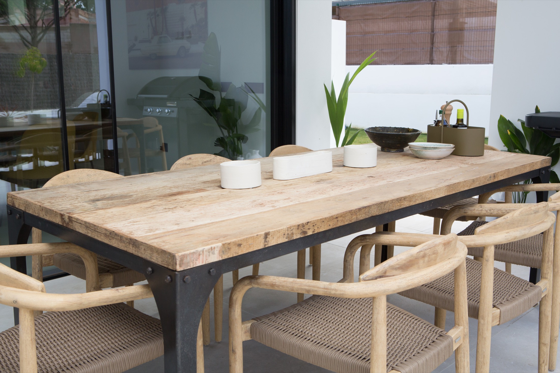 A sunlit terrace dining setting at a VIVLA home